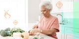 Woman using a digital assistant while prepping veggies in her kitchen.