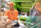 A sanitation engineer picking up trash.